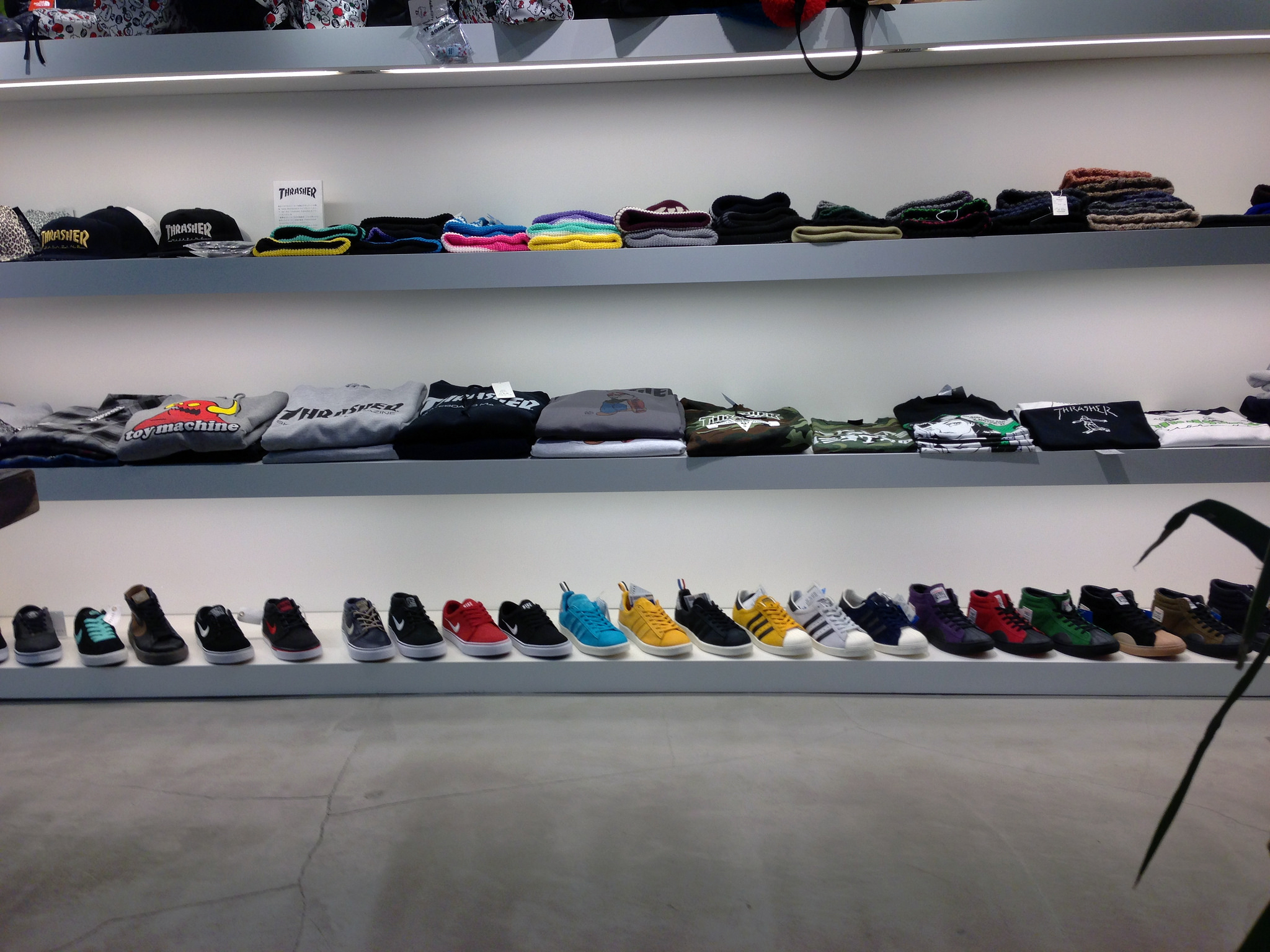 Sneaker and t-shirt wall at atmos in Tokyo. Photo by alphacityguides.