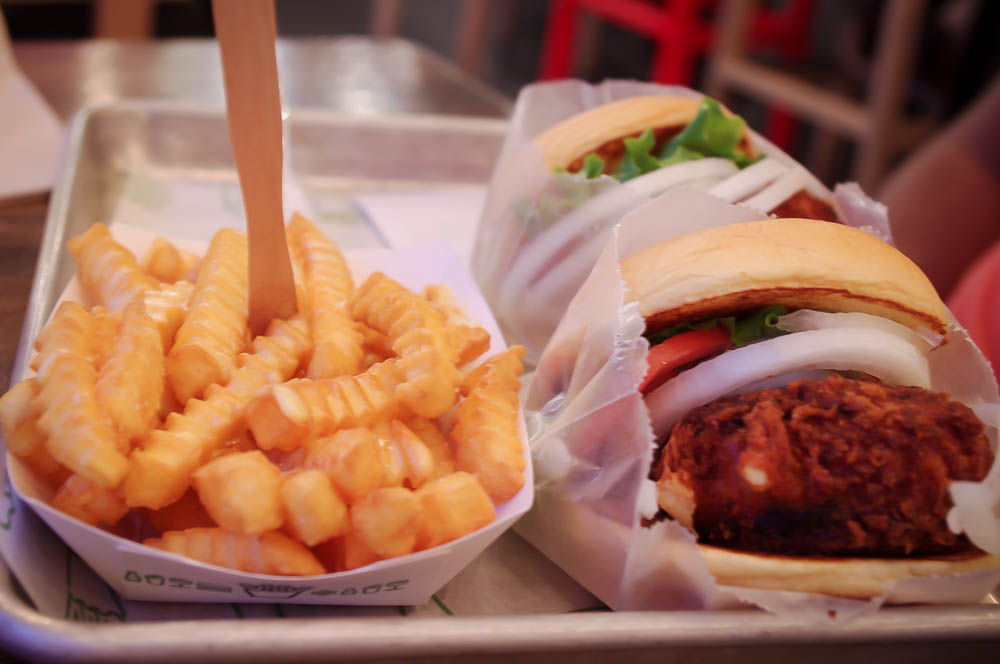 Shroom burgers (deep fried cheese and portabello pattie) & fries at Shake Shack, New York. Photo by alphacityguides.