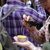 Tourist taking a photo of the egg tart at Tai Cheong Bakery in Hong Kong. Photo by alphacityguides.