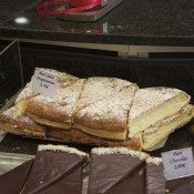 Tarte Tropezienne slices on display at La Fougasse in Paris