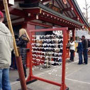 Omikuji rack to tie fortunes at Sensoji Temple in Tokyo. Photo by alphacityguides.