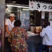 Man at the Tsukiji fish market in Tokyo. Photo by alphacityguides.