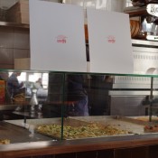 Where the magic happens—the pizza counter at Al Taglio in Paris. Photo by alphacityguides. 
