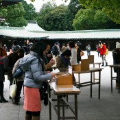 Locals writing prayers on Ema tables at Meiji Shrine in Tokyo. Photo by alphacityguides.