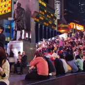 Tourist look out at Time Square in New York. Photo by alphacityguides.