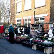 Flower vendors at Columbia Road Flower Market in London. Photo by alphacityguides.
